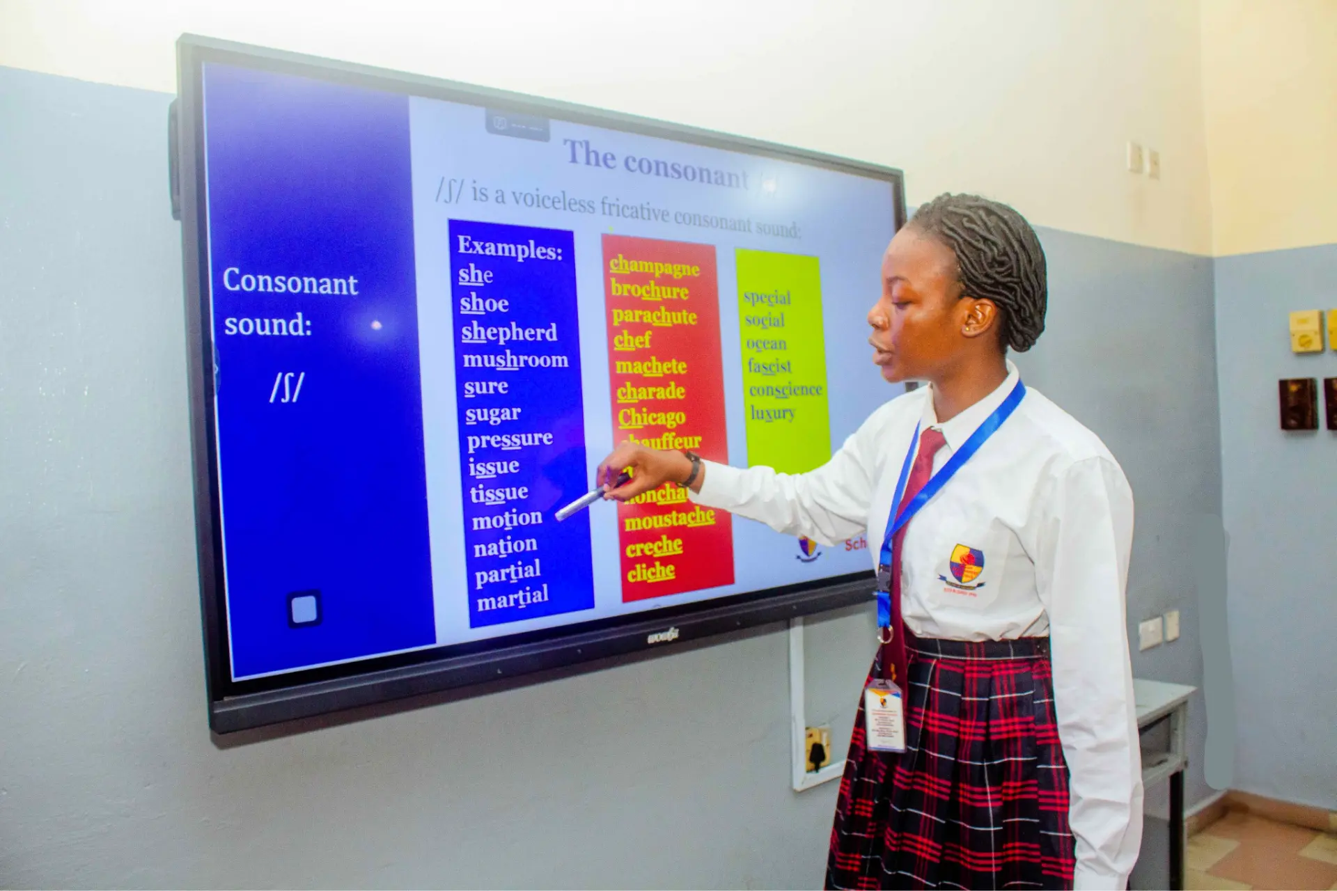 Student presenting on an interactive smart board